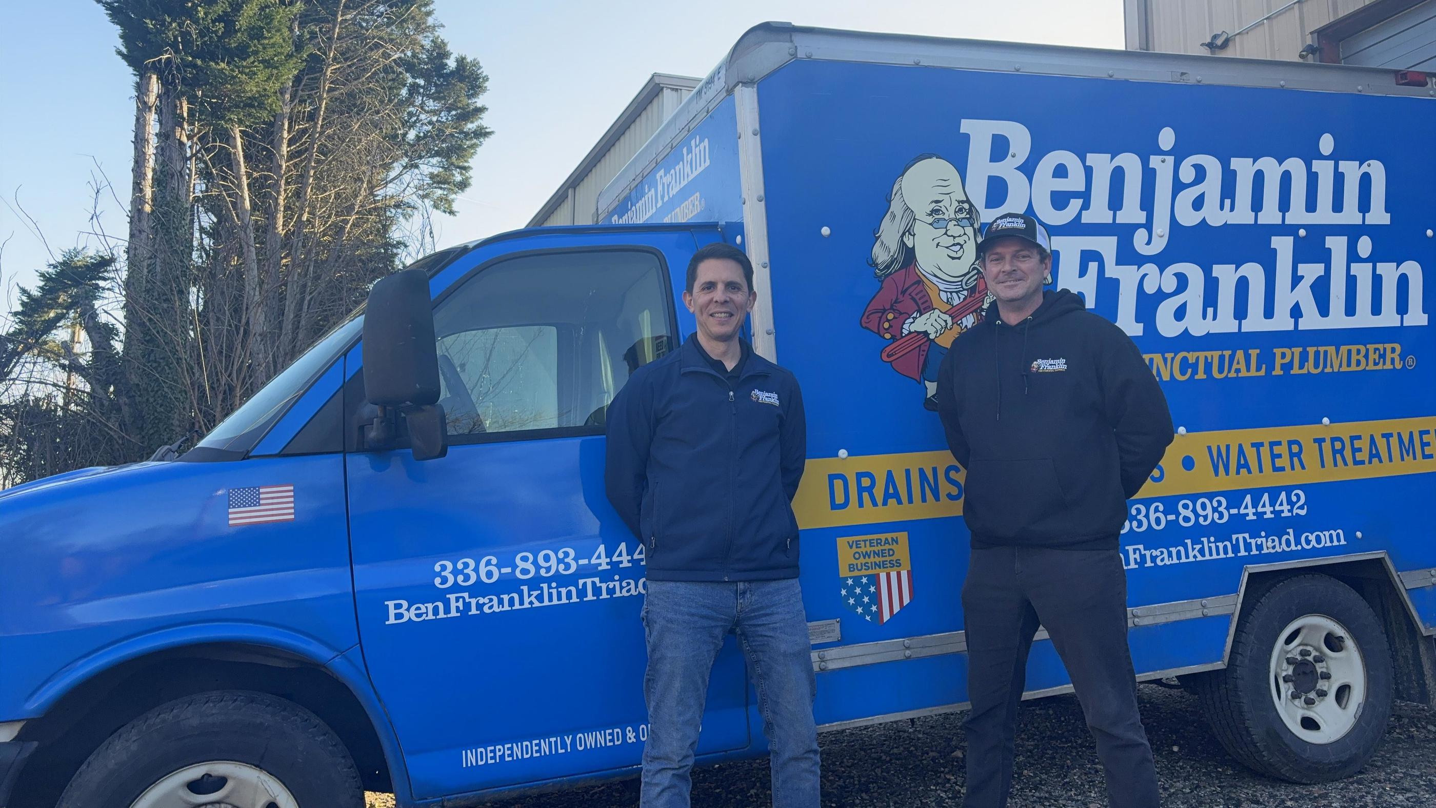 Benjamin Franklin Plumbing of Triad workers standing in front of truck