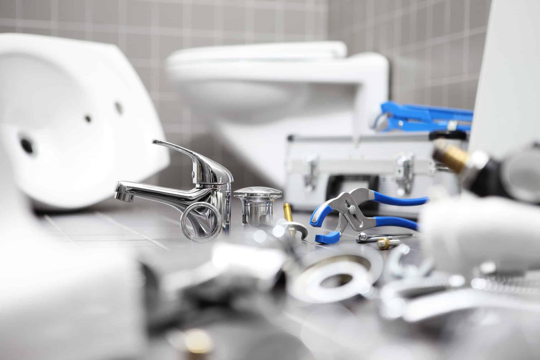 plumbing fixtures laying on bathroom floor