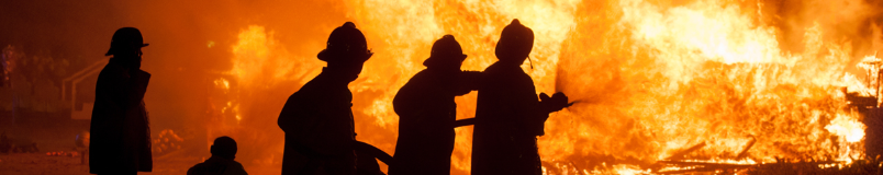 firefighters spraying water on fire