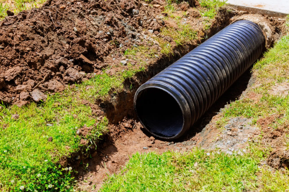 black storm drain coming out of ground