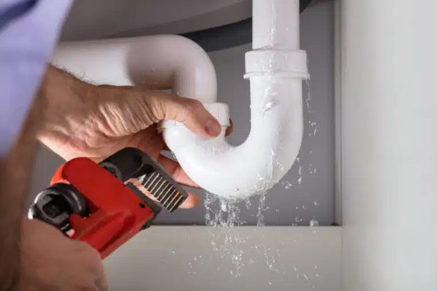 leaking P trap and hand trying to fix it