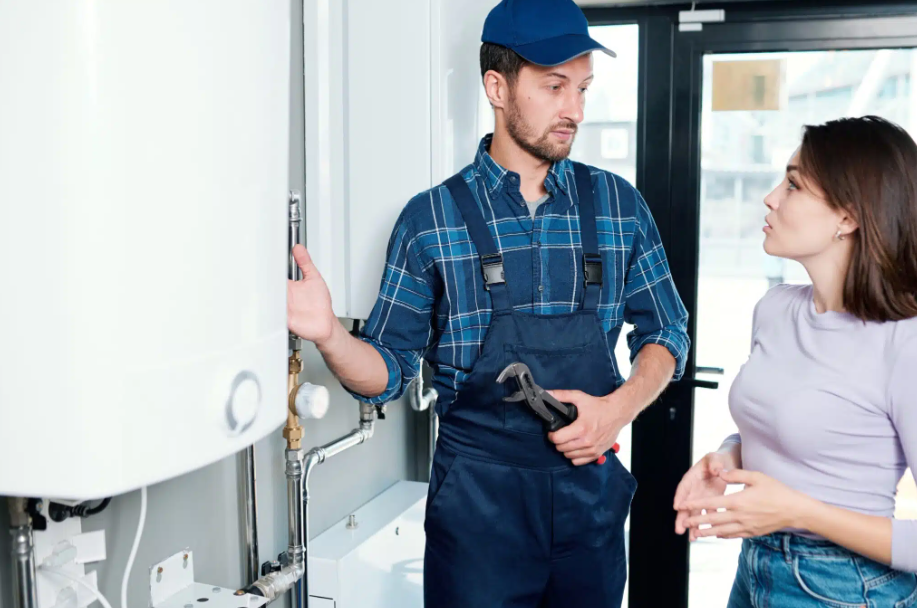 plumber explaining tank to homeowner