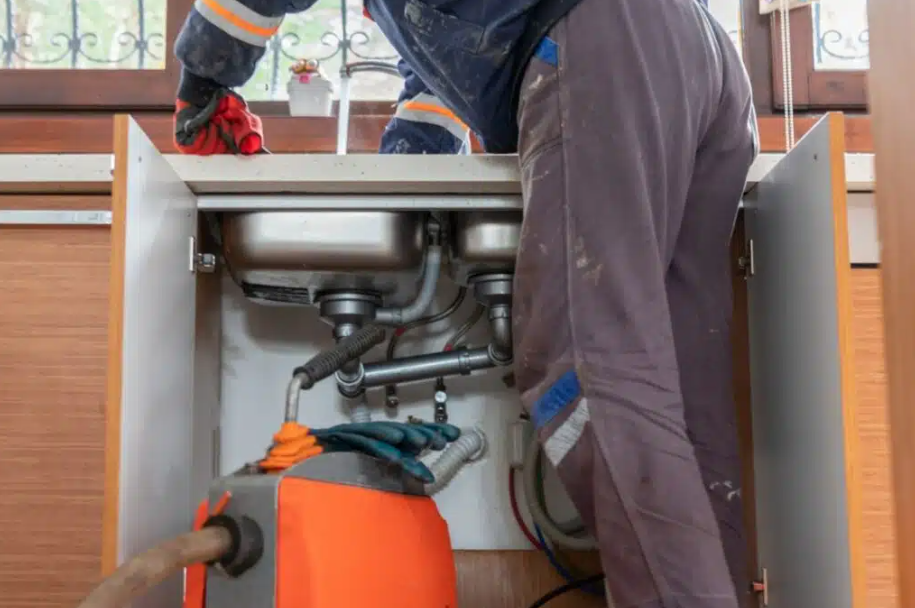plumber fixing kitchen sink