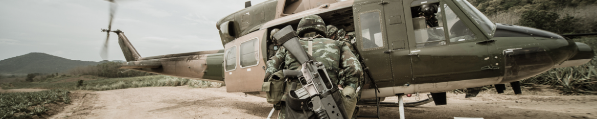 soldiers running to helicopter