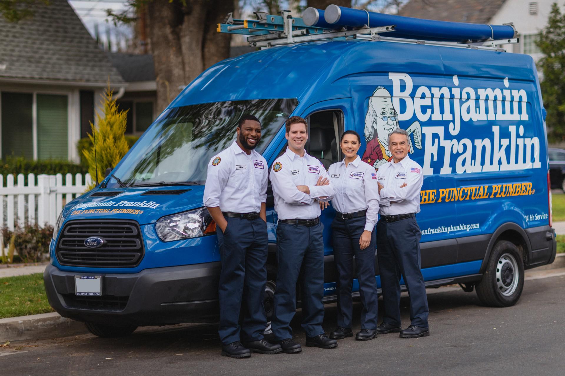 technicians smiling in front a truck